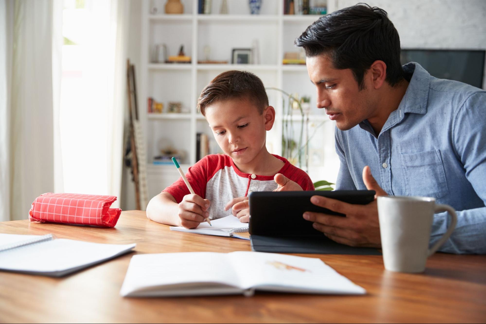 Dad helping son with homework ©Monkey Business Images