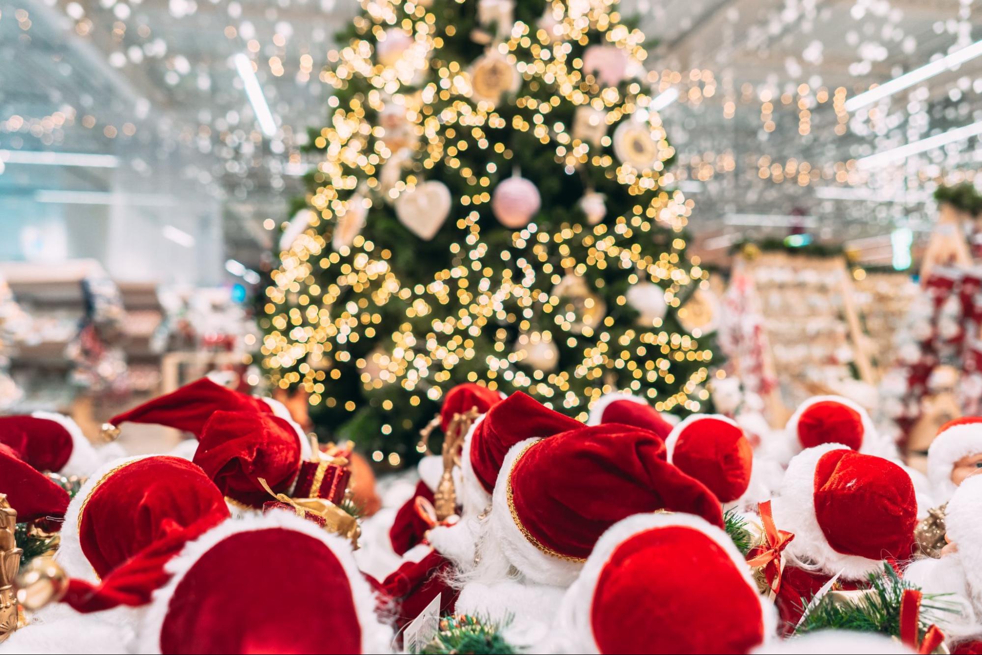 Santa hats looking up at a christmas tree ©Hrecheniuk Oleksii